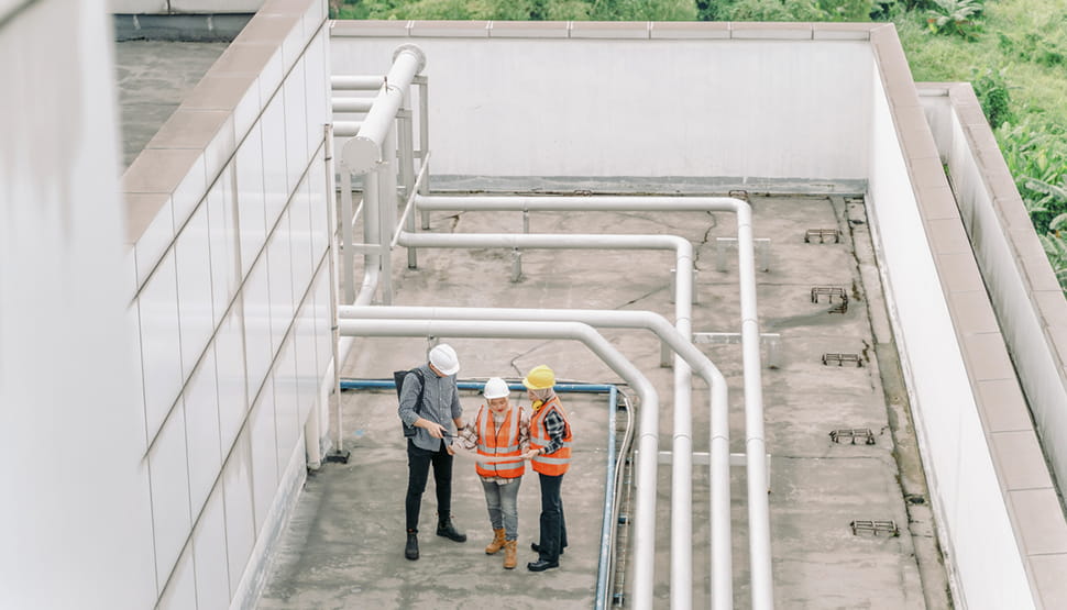 Three Workers On A Roof